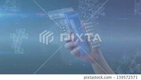Holding right hand and arm at studio wearing light cuff, projecting holographic UI from clear phone Holding right hand and arm at studio wearing light cuff, projecting holographic UI from clear phone 139572571