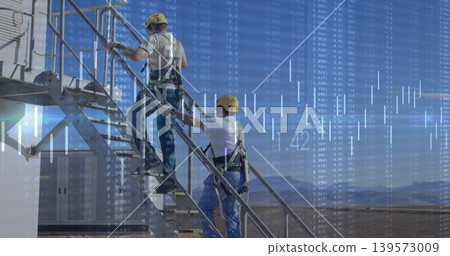 Climbing two workers wearing yellow hard hats and harnesses on metal stairs with financial charts Climbing two workers wearing yellow hard hats and harnesses on metal stairs with financial charts 139573009