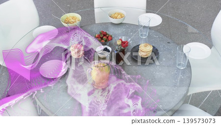 Showing round glass table holding pancakes syrup juice cereal fruit in dining under magenta overlay Showing round glass table holding pancakes syrup juice cereal fruit in dining under magenta overlay 139573073