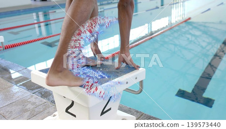 Poising swimmer in swimwear gripping starting block 2 at pool with red lane ropes, particle swirl Poising swimmer in swimwear gripping starting block 2 at pool with red lane ropes, particle swirl 139573440