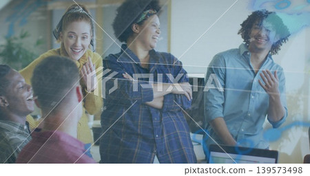 Laughing six casual coworkers discussing at office desk with laptop and reflective glass overlay Laughing six casual coworkers discussing at office desk with laptop and reflective glass overlay 139573498