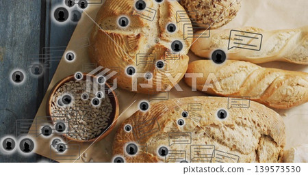 Displaying assortment of artisan breads on parchment at studio table, with seed bowl overlays Displaying assortment of artisan breads on parchment at studio table, with seed bowl overlays 139573530