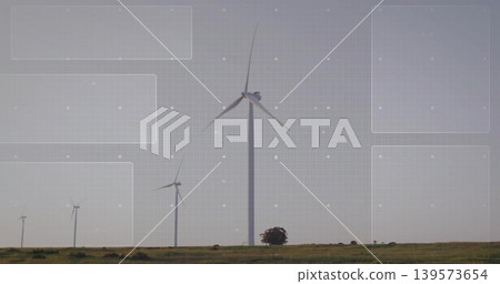 Featuring large central wind turbine rotating three-blade rotor on grassy plain, showing grid Featuring large central wind turbine rotating three-blade rotor on grassy plain, showing grid 139573654
