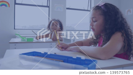 Writing girl student in sleeveless pink top leaning over paper at school, yellow pencil showing Writing girl student in sleeveless pink top leaning over paper at school, yellow pencil showing 139573765