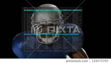 Standing football player wearing blue pads in studio, with white helmet facemask and cyan terminal Standing football player wearing blue pads in studio, with white helmet facemask and cyan terminal 139573797