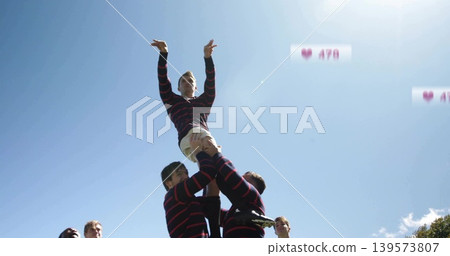 Lifting athlete reaching on grass, in striped jersey and white shorts, cleats, tape, heart icons Lifting athlete reaching on grass, in striped jersey and white shorts, cleats, tape, heart icons 139573807