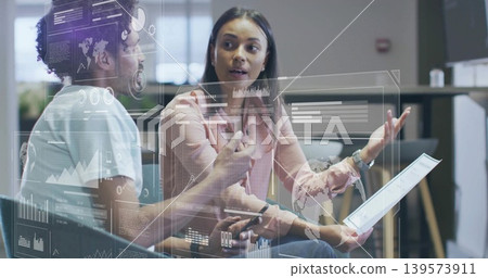 Analyzing AR overlays, two colleagues wearing pink blouse, light shirt with tablet, pen in office Analyzing AR overlays, two colleagues wearing pink blouse, light shirt with tablet, pen in office 139573911