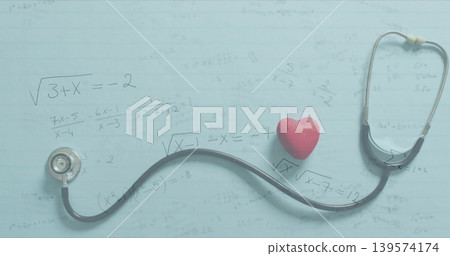 Displaying stethoscope curving across pale blue sheet with algebra equations, red heart accent Displaying stethoscope curving across pale blue sheet with algebra equations, red heart accent 139574174