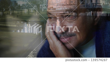 Resting hand under cheek, senior man gazing away at marina, water reflections, wearing navy sweater Resting hand under cheek, senior man gazing away at marina, water reflections, wearing navy sweater 139574287