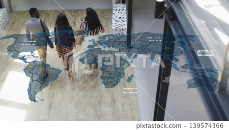 Walking three adults in business attire carrying shoulder bags, talking in atrium with map overlay Walking three adults in business attire carrying shoulder bags, talking in atrium with map overlay 139574366