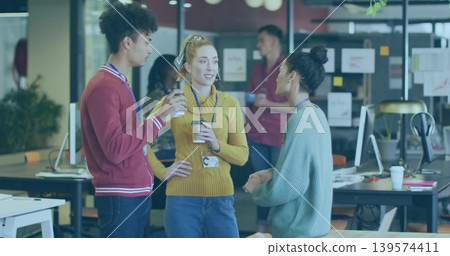 Talking coworkers in maroon, mustard, teal sweaters, standing in open office with coffee, lanyards Talking coworkers in maroon, mustard, teal sweaters, standing in open office with coffee, lanyards 139574411