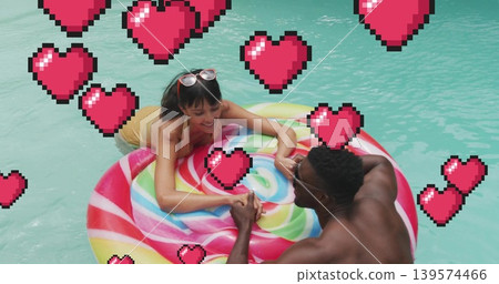 Leaning couple smiling on swirl float in pool, wearing yellow suit dark trunks shades pixel hearts Leaning couple smiling on swirl float in pool, wearing yellow suit dark trunks shades pixel hearts 139574466