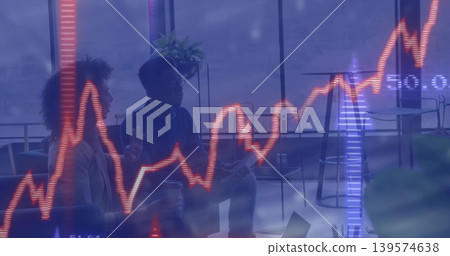 Talking team wearing business attire holding coffee cup, tablet in office lounge with chart overlay Talking team wearing business attire holding coffee cup, tablet in office lounge with chart overlay 139574638