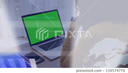 Typing woman in mustard top using laptop green screen at home, tablet, phone, overlays, copy space Typing woman in mustard top using laptop green screen at home, tablet, phone, overlays, copy space 139574778