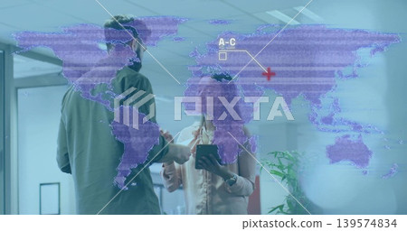 Discussing colleagues holding tablet and gesturing at glass wall map in office, in shirt and blouse Discussing colleagues holding tablet and gesturing at glass wall map in office, in shirt and blouse 139574834