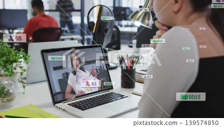 Watching woman wearing light top, viewing online call at open office on silver laptop, copy space Watching woman wearing light top, viewing online call at open office on silver laptop, copy space 139574850