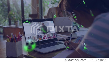 Writing child wearing striped top glasses attending remote class at table notebook laptop AR icons 139574853