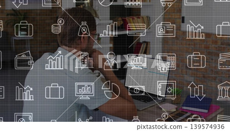 Resting chin midadult man wearing shirt specs viewing laptop phone at home office with icon overlay Resting chin midadult man wearing shirt specs viewing laptop phone at home office with icon overlay 139574936