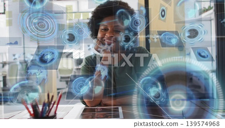 Gazing woman wearing muted green shirt at desk in modern office, with holographic UI Gazing woman wearing muted green shirt at desk in modern office, with holographic UI 139574968