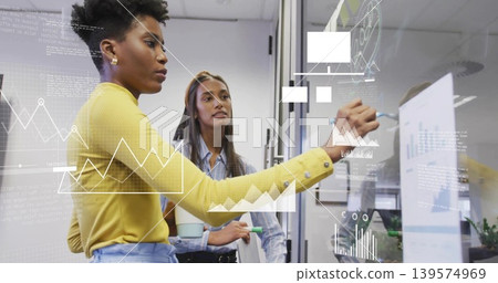 Writing woman wearing yellow top sketching data on glass partition, holding marker, copy space Writing woman wearing yellow top sketching data on glass partition, holding marker, copy space 139574969