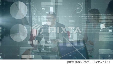 Leading man in dark suit presenting HUD charts in glass-walled conference room, with laptops Leading man in dark suit presenting HUD charts in glass-walled conference room, with laptops 139575144