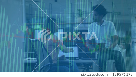 Pointing two analysts in polo and blouse analyzing market charts at office with laptop, tablet Pointing two analysts in polo and blouse analyzing market charts at office with laptop, tablet 139575173