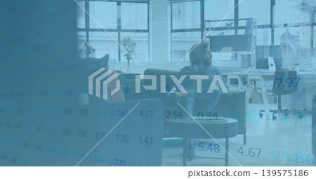 Sitting adult male in sweater, pants studying data overlay in office lounge, with sofa and monitor Sitting adult male in sweater, pants studying data overlay in office lounge, with sofa and monitor 139575186