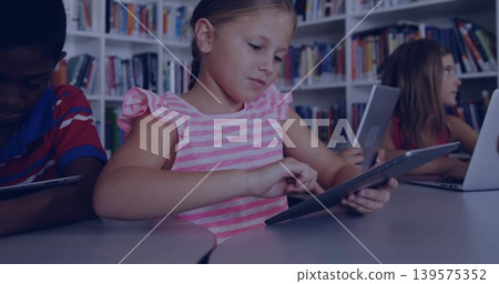 Tapping girl in pink ruffle-sleeve top using tablet at school library, with laptop, books Tapping girl in pink ruffle-sleeve top using tablet at school library, with laptop, books 139575352