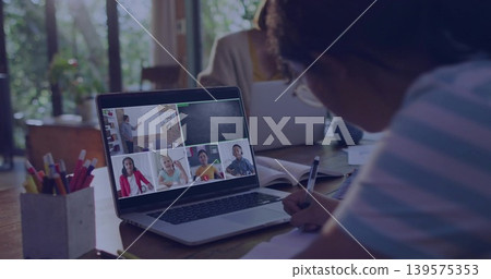 Writing girl wearing striped shirt joining online class at home using laptop pencil cup, copy space Writing girl wearing striped shirt joining online class at home using laptop pencil cup, copy space 139575353
