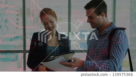 Reviewing coworkers in business wear, examining tablet and papers in modern office with overlay Reviewing coworkers in business wear, examining tablet and papers in modern office with overlay 139575368