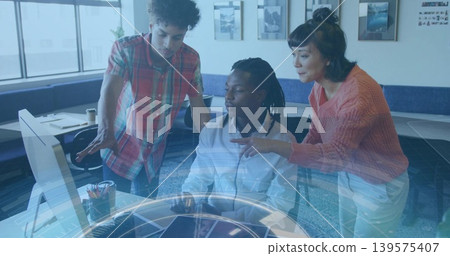 Working team around seated man wearing white shirt operating computer in office, holographic UI Working team around seated man wearing white shirt operating computer in office, holographic UI 139575407
