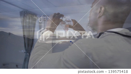 Holding clinician adjusting respirator mask and tubing in clinic with stethoscope, coat, landscape Holding clinician adjusting respirator mask and tubing in clinic with stethoscope, coat, landscape 139575418