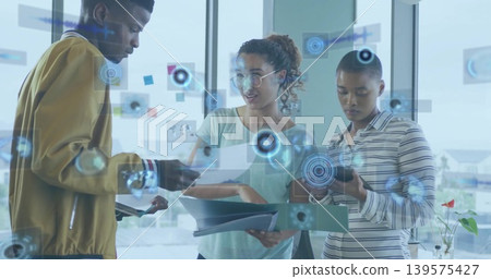 Reviewing three colleagues examining documents and phone at office, with AR graphics and red flower Reviewing three colleagues examining documents and phone at office, with AR graphics and red flower 139575427