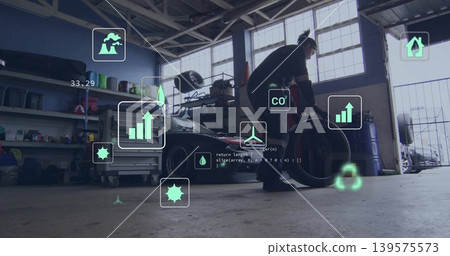 Bending mechanic in coveralls lifting tire near sports car in garage with AR overlays, copy space Bending mechanic in coveralls lifting tire near sports car in garage with AR overlays, copy space 139575573