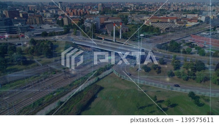 Showing highway overpass carrying multilane traffic above rail junction at city edge, grid overlay Showing highway overpass carrying multilane traffic above rail junction at city edge, grid overlay 139575611