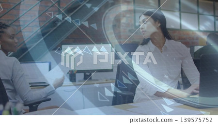 Discussing woman in white shirt reviewing laptop screen at shared desk, with documents and HUD Discussing woman in white shirt reviewing laptop screen at shared desk, with documents and HUD 139575752