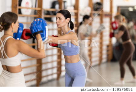 Young women in gym boxing training Young women in gym boxing training 139576091
