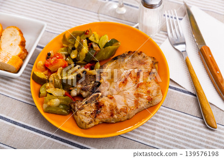 Juicy roast pork on a plate with stewed vegetables Juicy roast pork on a plate with stewed vegetables 139576198