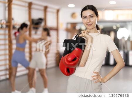 Young girl posing with boxing gloves Young girl posing with boxing gloves 139576386