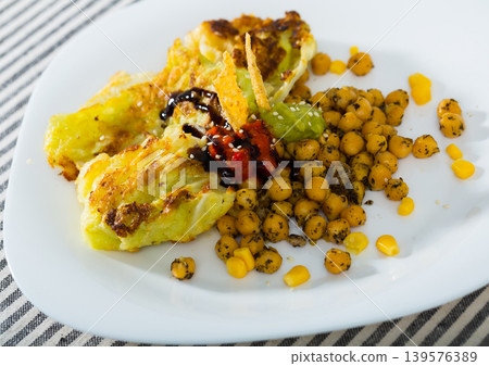 Breaded cabbage leaves with sauces and garbanzos 139576389