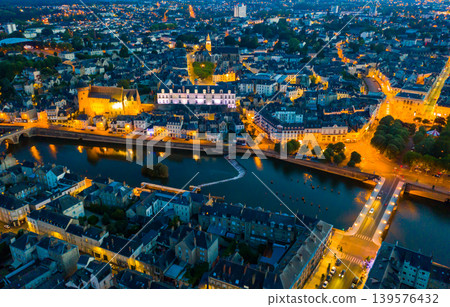Evening aerial view of Laval with buildings, river Mayenne and old bridge Evening aerial view of Laval with buildings, river Mayenne and old bridge 139576432