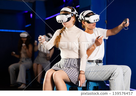 Girls using virtual reality glasses - girlfriends having fun with vr headset 139576457