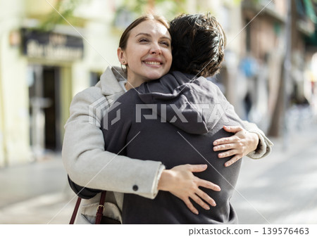 Young couple hugging each other on city street Young couple hugging each other on city street 139576463
