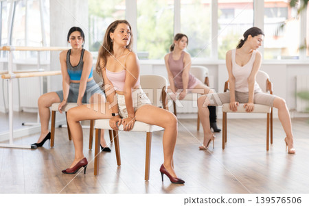 Sitting on chair, girl train to perform lap dance, interacting with imaginary partner 139576506