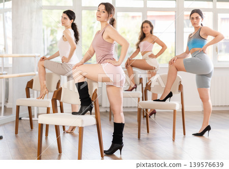 Young girl performing sass dance with chair at group class 139576639