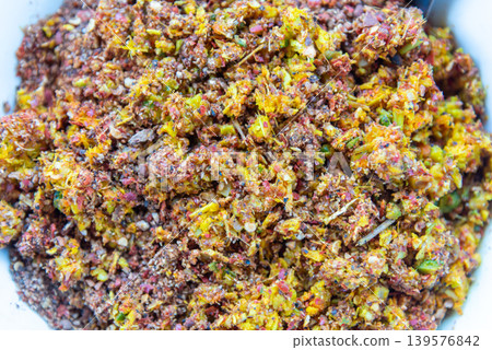 Closeup of spicy Thai chili herb seasoning mix with crushed spices and colorful ingredients showing rich texture and traditional Asian food preparation Closeup of spicy Thai chili herb seasoning mix with crushed spices and colorful ingredients showing rich texture and traditional Asian food preparation 139576842