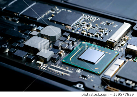 Close-up part of motherboard from laptop computer show up a CPU and other components on board Close-up part of motherboard from laptop computer show up a CPU and other components on board 139577659
