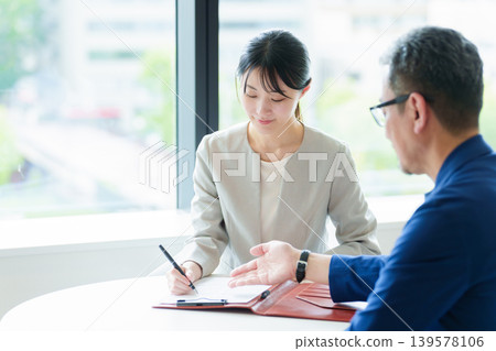 A woman who signs a contract A woman who signs a contract 139578106