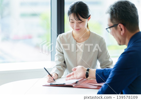 A woman who signs a contract A woman who signs a contract 139578109