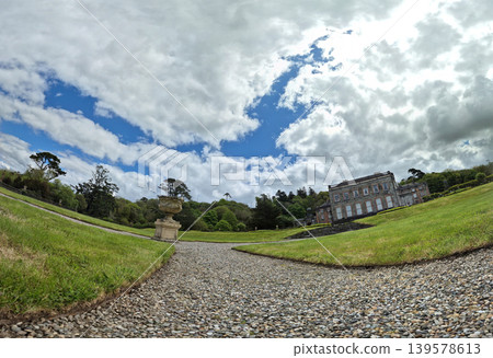 Historic country estate with formal garden and dramatic sky 139578613
